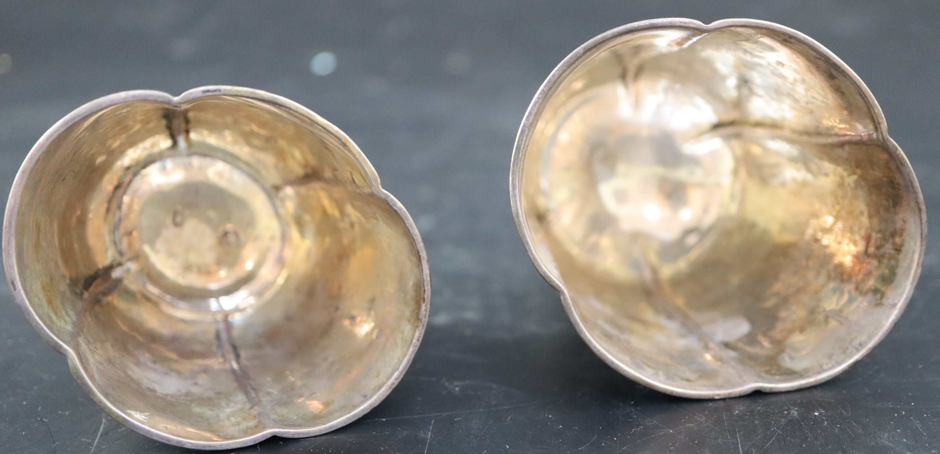 A graduated pair of Continental white metal cusped small vases, tallest 7cm, 215 grams